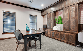 A meeting room with a desk and chairs